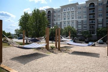 Vernon Hills apartment for rent - A hammock is strung between two wooden posts in a gravel courtyard.