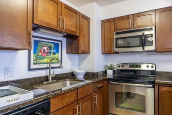 Corner kitchen with granite counters and stainless appliances