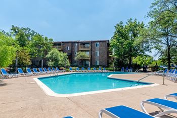 Swimming pool surrounded by blue lounge chairs