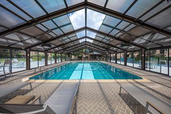 Heated indoor/outdoor swimming pool with retractable roof and sundeck