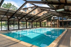 Naperville apartment for rent - A large indoor swimming pool with a glass ceiling.