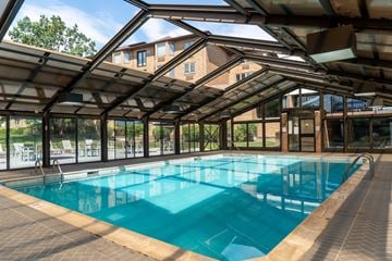 Naperville apartment for rent - A large indoor swimming pool with a glass ceiling.