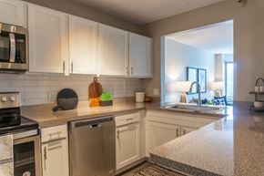 Naperville apartment for rent - A kitchen with white cabinets and stainless steel appliances.