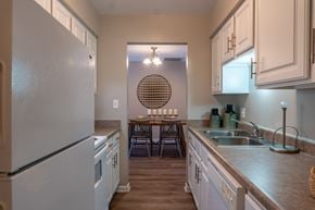 Mundelein apartment for rent - A kitchen with a white refrigerator and a round window.