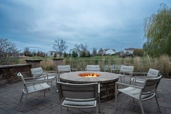 Natural gas firepit with stone seating wall