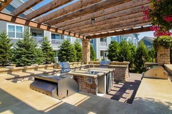 Outdoor patio featuring custom stone grilling and entertainment center