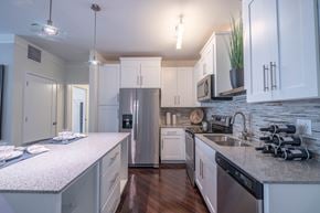 St. Charles apartment for rent - A kitchen with white cabinets and a granite countertop.