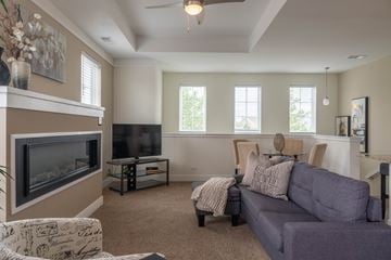 St. Charles apartment for rent - A living room with a grey couch and a fireplace.
