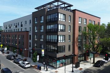 Evanston apartment for rent - A street view of a city with cars and buildings.