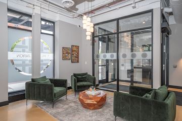 Evanston apartment for rent - A living room with green velvet chairs and a wooden coffee table.