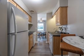Glen Ellyn apartment for rent - A kitchen with a refrigerator, table and chairs.