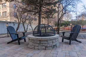Chicago apartment for rent - A fire pit surrounded by two chairs on a patio.