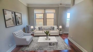 Chicago apartment for rent - A living room with a white couch and a grey rug.
