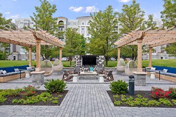 Outdoor lounge with fireplace and covered seating areas