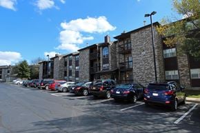 Bloomingdale apartment for rent - A parking lot with cars parked in front of a building.