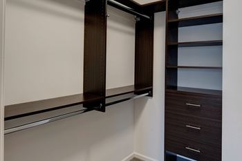 Walk-in closet with custom shelving and drawers
