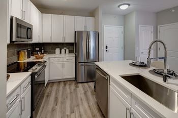 Modern kitchen island with undermount sink and commercial faucet