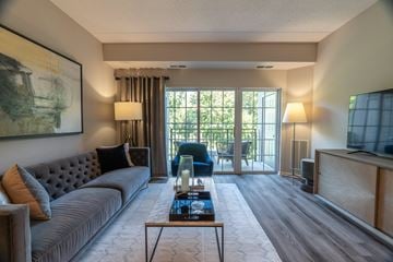 Vernon Hills apartment for rent - A living room with a grey sofa and a painting on the wall.
