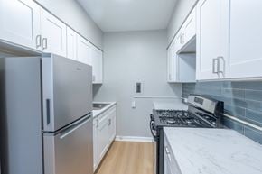 Chicago apartment for rent - A kitchen with a refrigerator, stove, and cabinets.