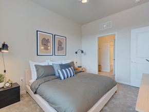 Denver apartment for rent - a bedroom with a bed and a door to a hallway