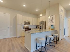 Denver apartment for rent - a kitchen with a bar and stools