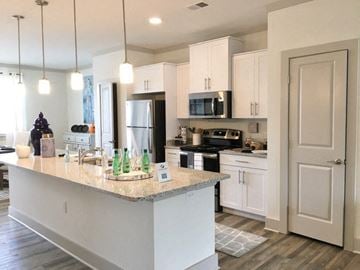 Asheville apartment for rent - a kitchen with white cabinets and a counter top