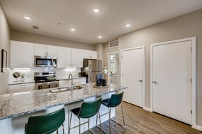 Greeley apartment for rent - a kitchen with a granite counter top and a sink