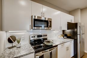 Greeley apartment for rent - a kitchen with stainless steel appliances and granite counter tops
