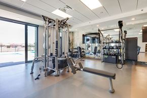 Greeley apartment for rent - a gym with weights and other exercise equipment and a large window