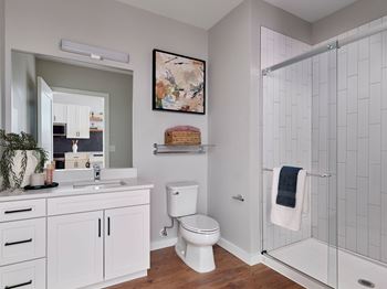 Spa-like bathrooms boast showers with glass doors or deep-soaking tubs and tile-surround, quartz countertops, and glazed porcelain tile flooring