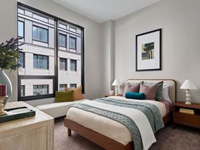 Philadelphia apartment for rent - A bedroom with a large bed and a large window.