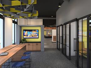 Philadelphia apartment for rent - A modern office space with a TV mounted on the wall and a long wooden table with chairs.