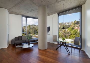 West Hollywood apartment for rent - A living room with a grey couch and a white table.