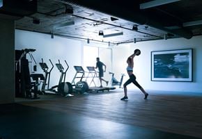 West Hollywood apartment for rent - A man is working out in a gym with a woman.