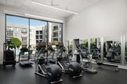 Clifton apartment for rent - A gym with a view of apartment buildings outside the large windows.