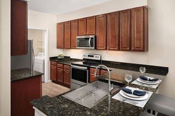 Clifton apartment for rent - A kitchen with brown cabinets and a granite counter top.