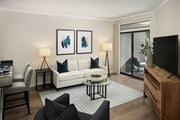 Clifton apartment for rent - A living room with a white sofa, a coffee table, and a television.