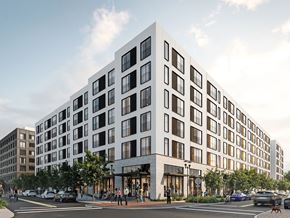 Philadelphia apartment for rent - A modern white building with black windows is situated on a street corner with cars and people around it.