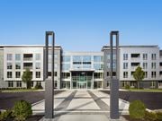 Florham Park apartment for rent - A modern building with two large pillars in front.