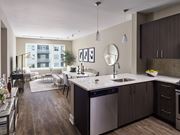 Florham Park apartment for rent - A modern kitchen with dark wood floors and stainless steel appliances.