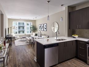 Florham Park apartment for rent - A modern kitchen with dark wood floors and stainless steel appliances.