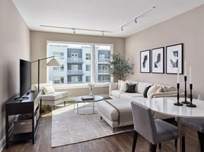 Florham Park apartment for rent - A modern living room with a large window overlooking a building.