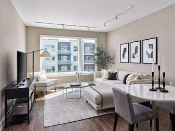 Florham Park apartment for rent - A modern living room with a large window overlooking a building.