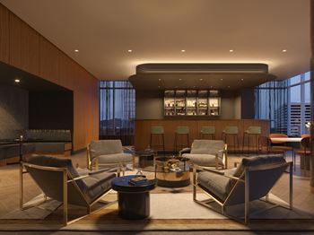 Elevated speakeasy with bar, high-top tables, and booths