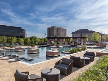 Spectacular resort-style pool and sundeck with in-lay loungers, cascading fountains, poolside cabanas, firepit, and a grilling station