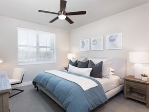 Irving apartment for rent - a bedroom with a large bed and a ceiling fan at AVE Las Colinas, Irving, TX