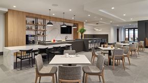 Philadelphia apartment for rent - A modern dining area with wooden chairs and tables.