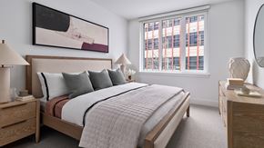 Philadelphia apartment for rent - A bedroom with a large bed, two nightstands, and a painting on the wall.