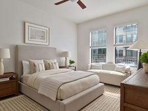 Phoenix apartment for rent - A bedroom with a large bed and a couch.