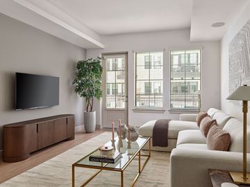 Phoenix apartment for rent - A living room with a glass coffee table and a large flat screen TV mounted on the wall.